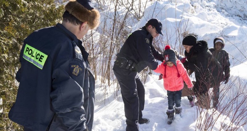 RCMP officers waiting for refugees to cross the U.S. border into Quebec.