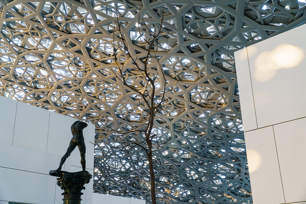 An-image-of-The-Walking-Man-by-Rodin-and-Leaves-of-Light-by-Penone-under-Louvre-Abu-Dhabi's-dome-©-Department-of-Culture-and-Tourism-Abu-Dhabi