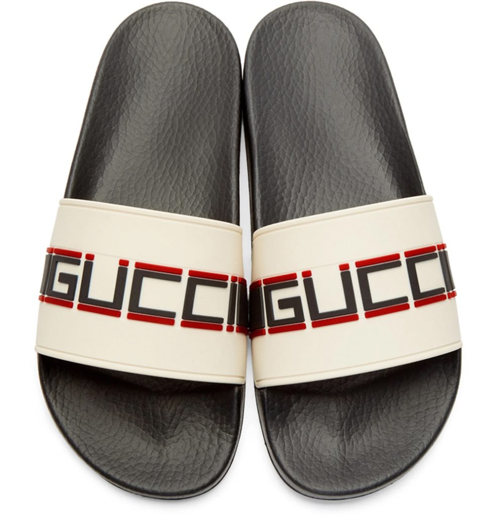 black gucci slides on feet