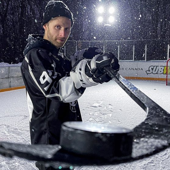 Pavel Barber holds a puck on his hockey stick