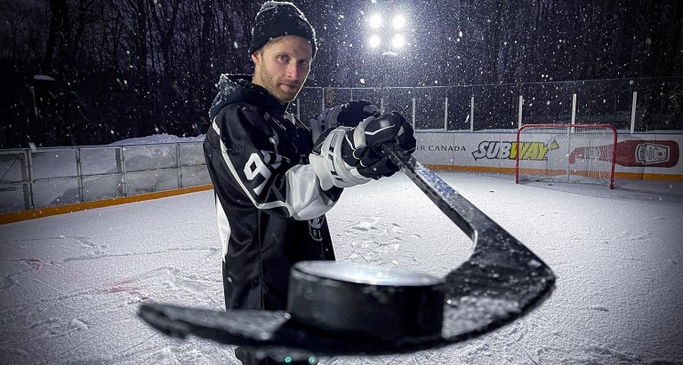 Pavel Barber holds a puck on his hockey stick