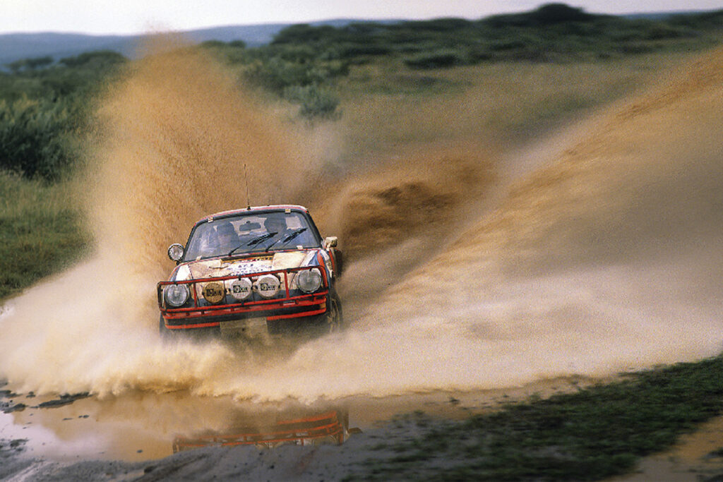 Porsche 911 Dakar driving through mud