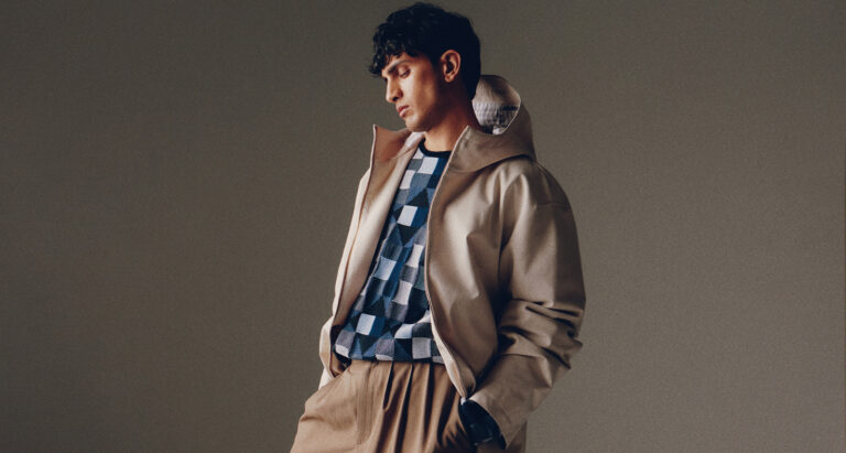 Model side profile in brown outfit with gradient background