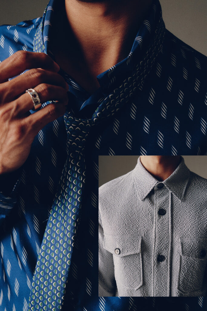 Grey collared shirt imposed over blue patterned tie