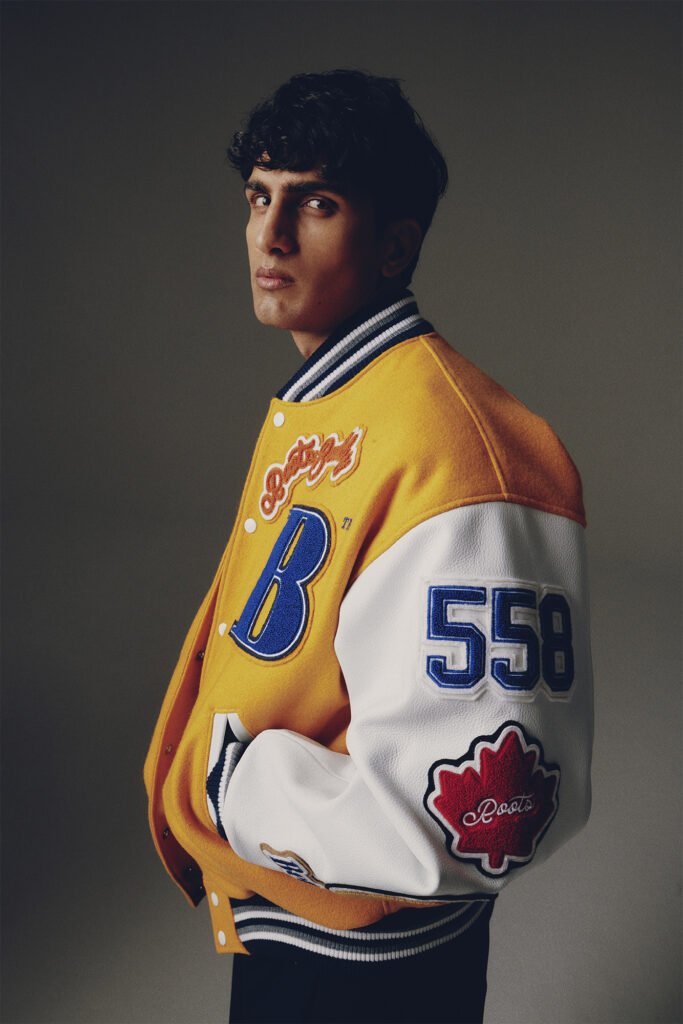 Model in yellow and blue varsity jacket