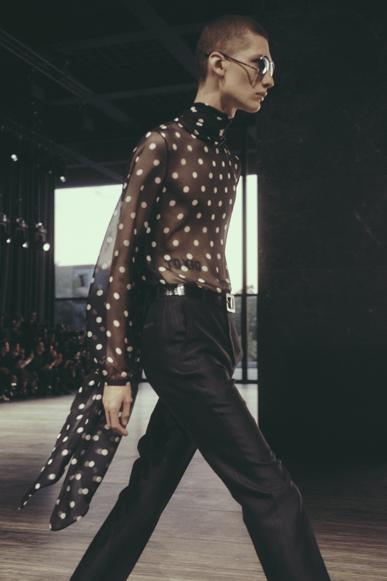 Saint Laurent Spring/Summer 2024 menswear model in sheer polka-dot top