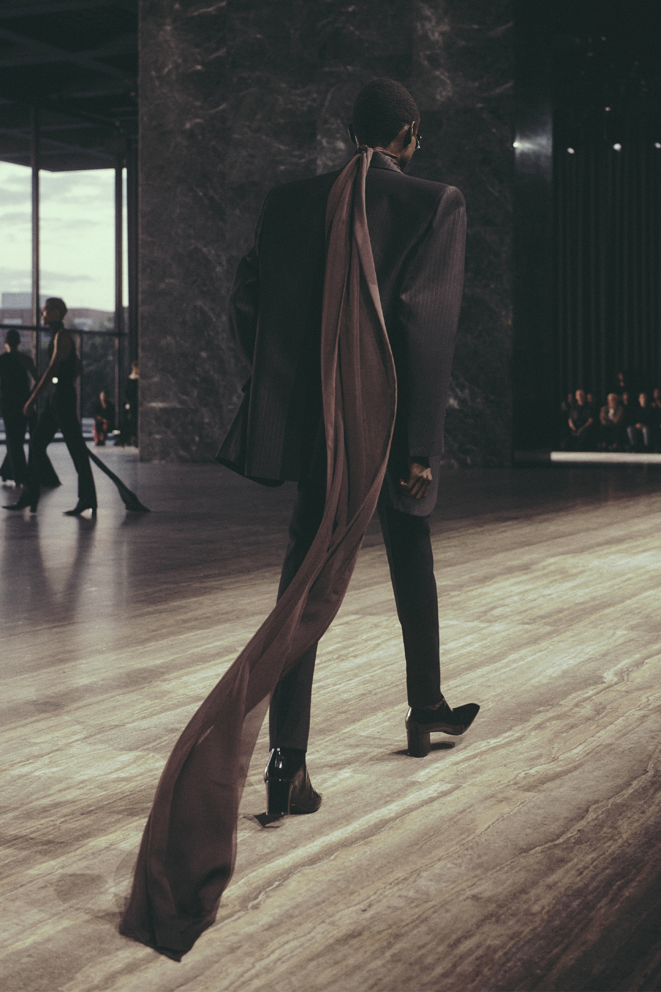Saint Laurent Spring/Summer 2024 menswear model with draped fabric from behind