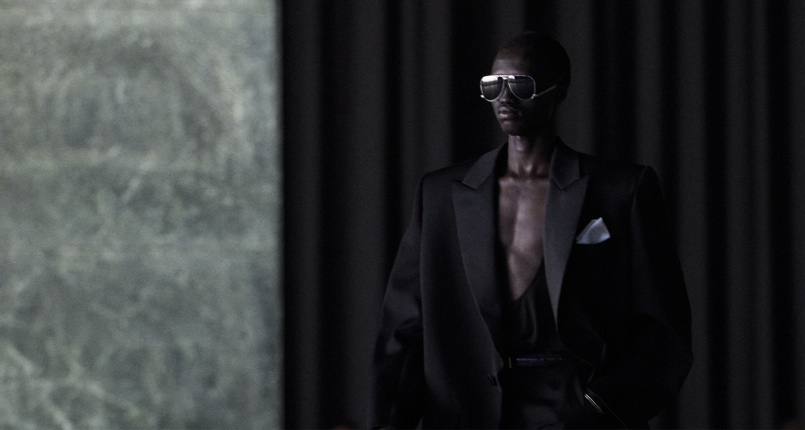 Saint Laurent Spring/Summer 2024 menswear model looking out with sunglasses