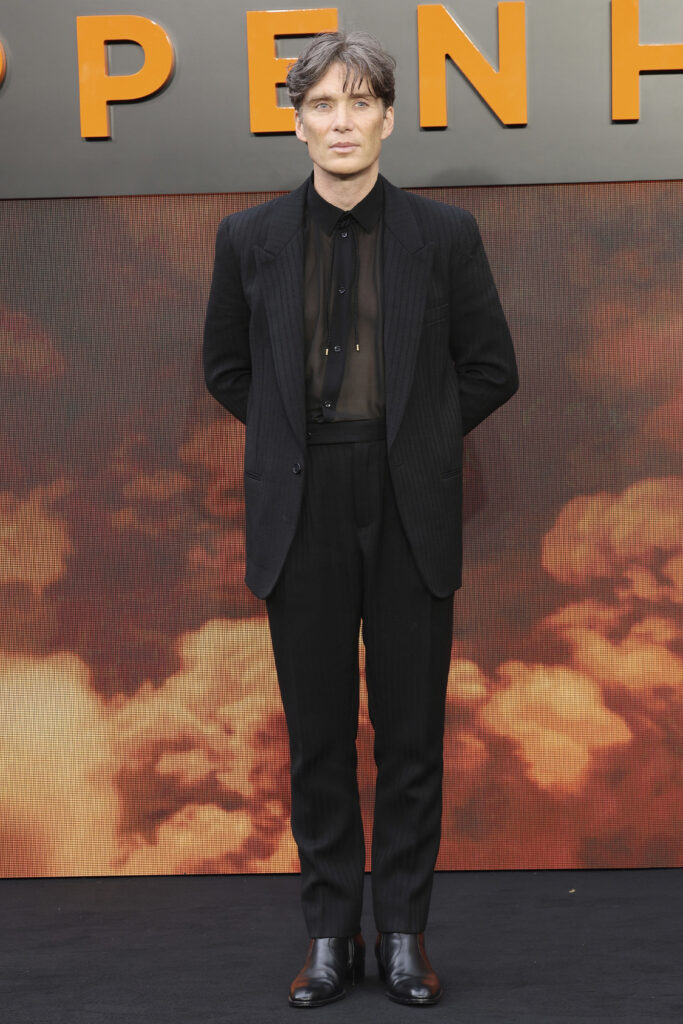 Cillian Murphy at the Oppenheimer premiere in a black suit jacket and pants, with a translucent black shirt