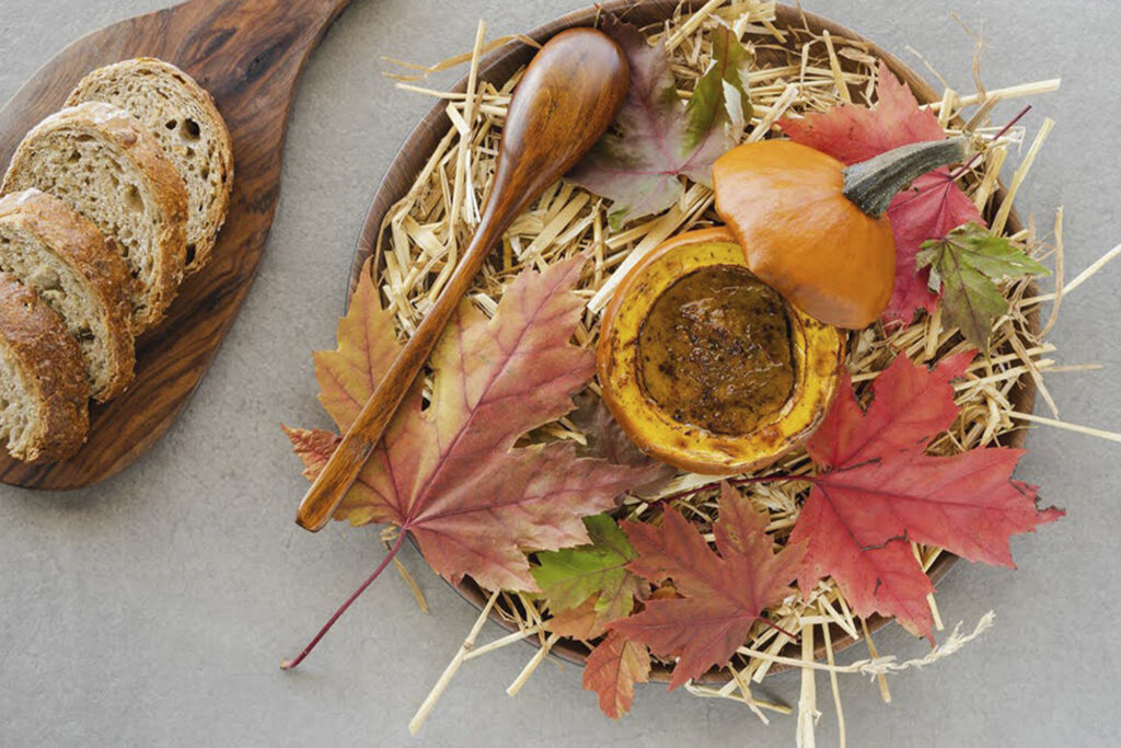 Frilu leaves and pumpkin on plate bread on plate to the left