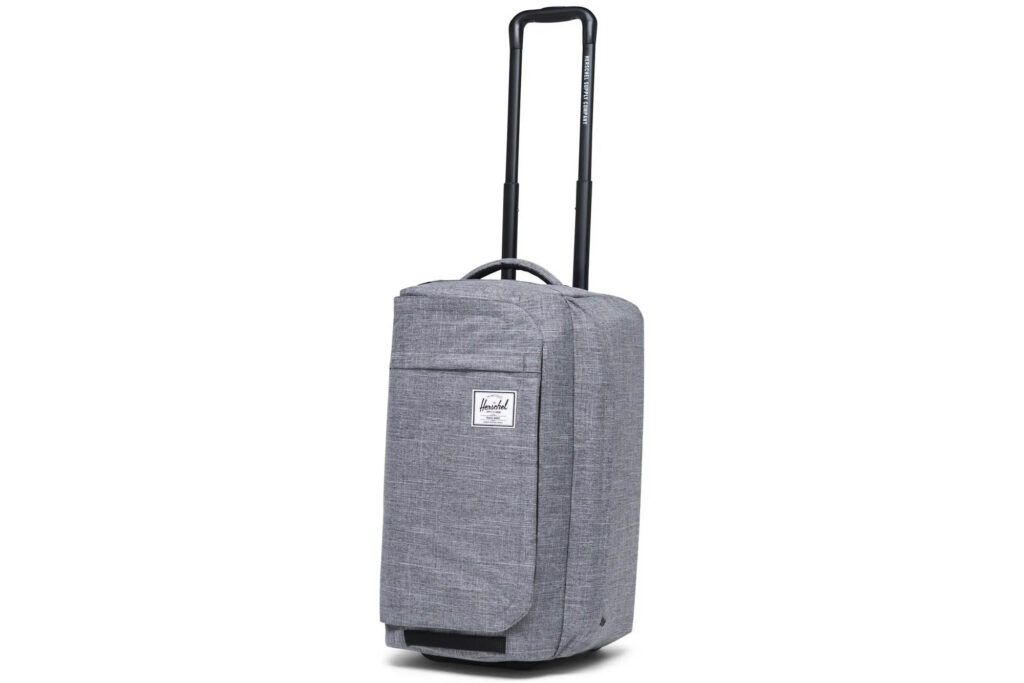 Hershel grey luggage bag upright from the side with handle up