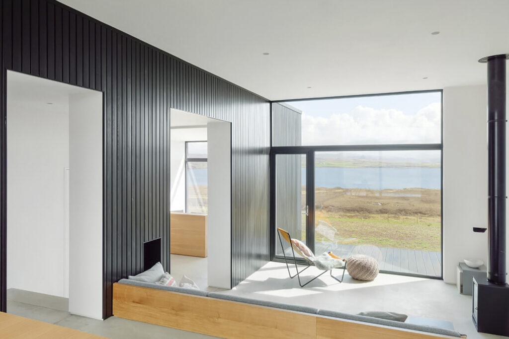 Harlosh Black H Home for rent in UK Scotland shot of interior black wall on left and window view straight on