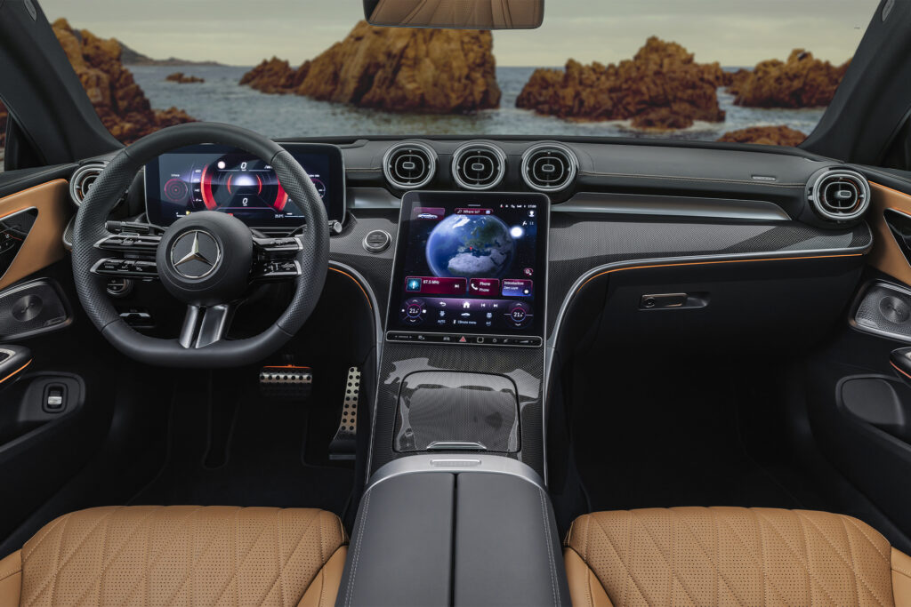 Mercedes CLE parked on beach setting. Photo shot from inside, showing dashboard and front seats