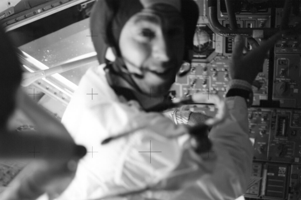 black and white photo of astronaut up close in space suit