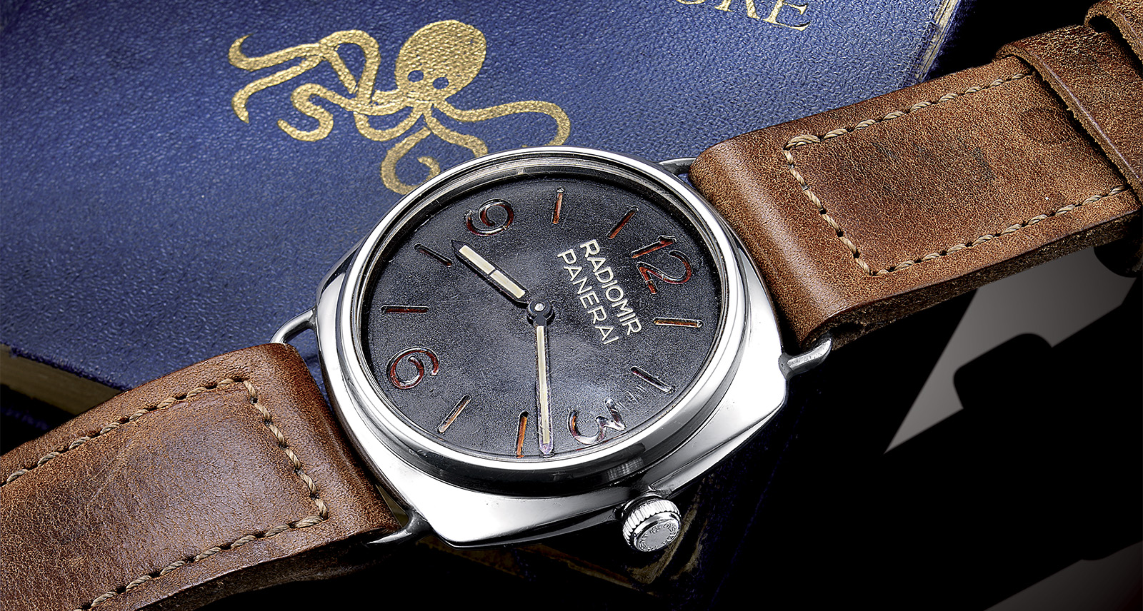 Panerai Radiomir Laid out over blue book