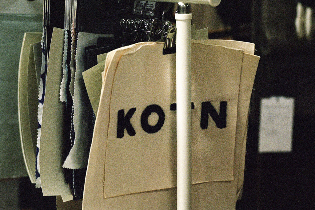 KOTIN labelled back hanging on rack inside boutique store