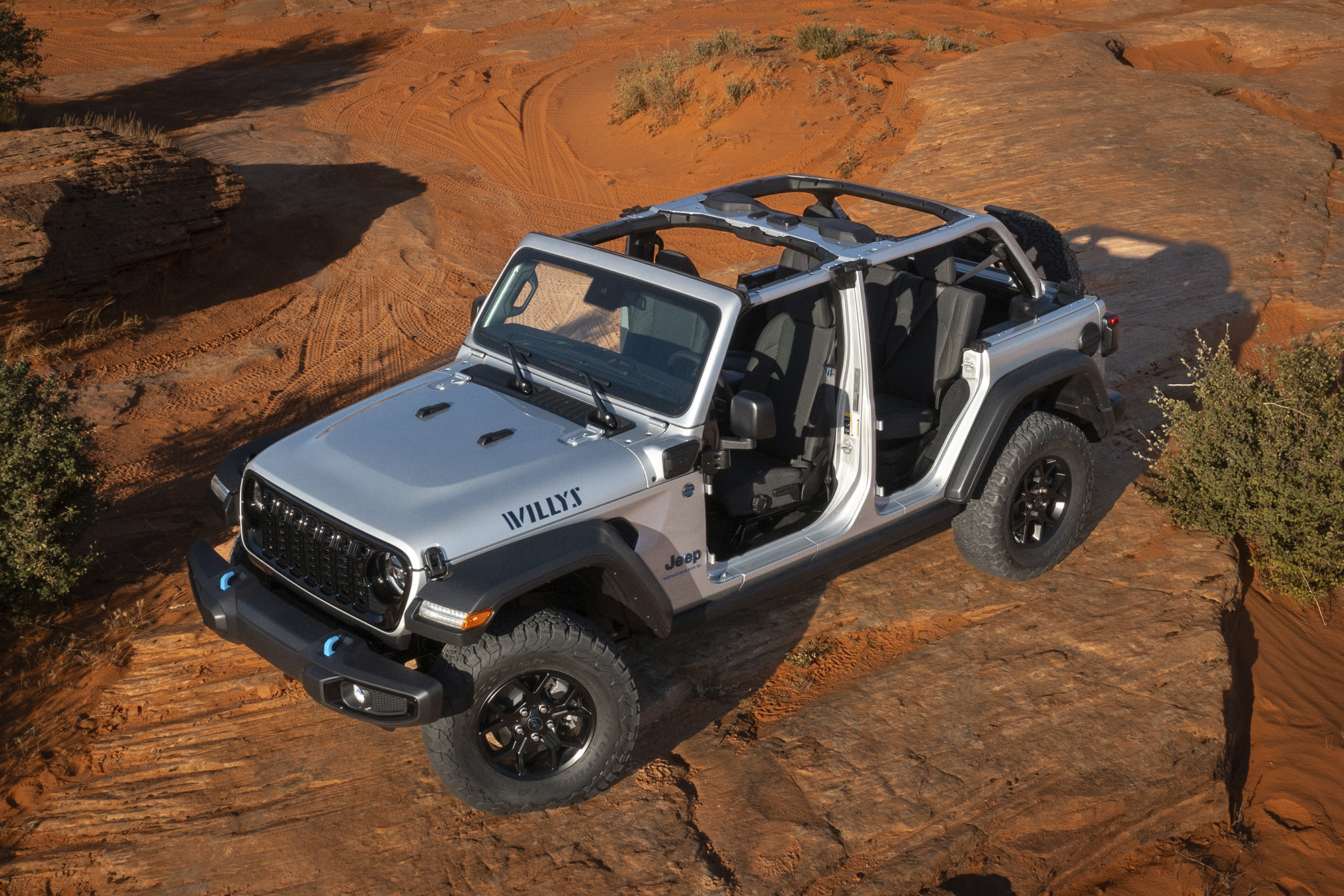 Jeep Wrangler bird's eye view of the boxy silver jeep parked in desert