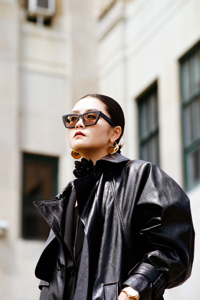 Yuki Zhao interview Range Rover content portrait in leather jacket and sunglasses by building