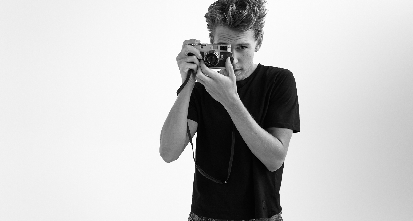 Austin Butler poses with camera for YSL Beauty MYSLF campaign, in black and white
