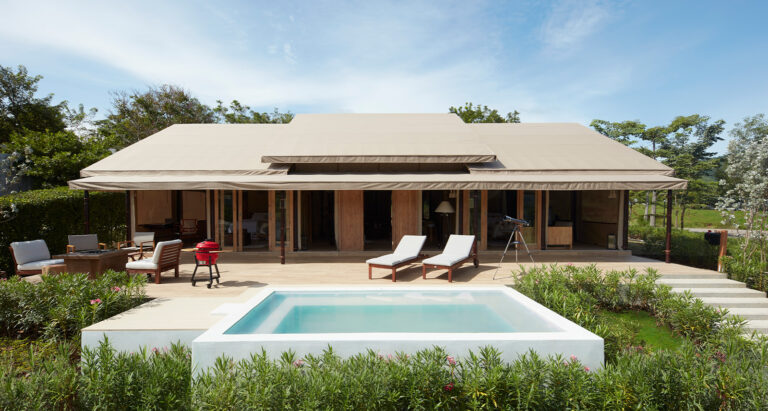 Resort in Thailand on a clear day with a pool in front