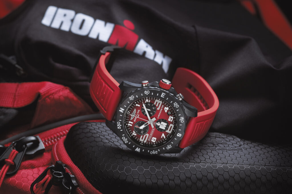 Limited Edition Breitling Endurance Pro for Ironman in red on Ironman promotional material with dial pointing toward camera