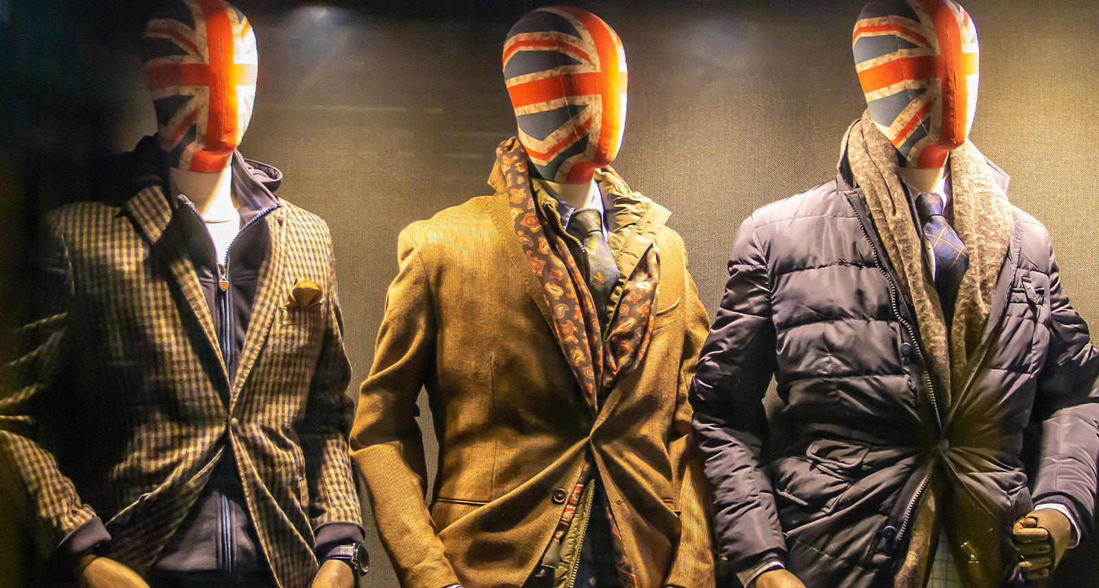 Three mannequins dressed in suits with the UK flag painted on their mannequin