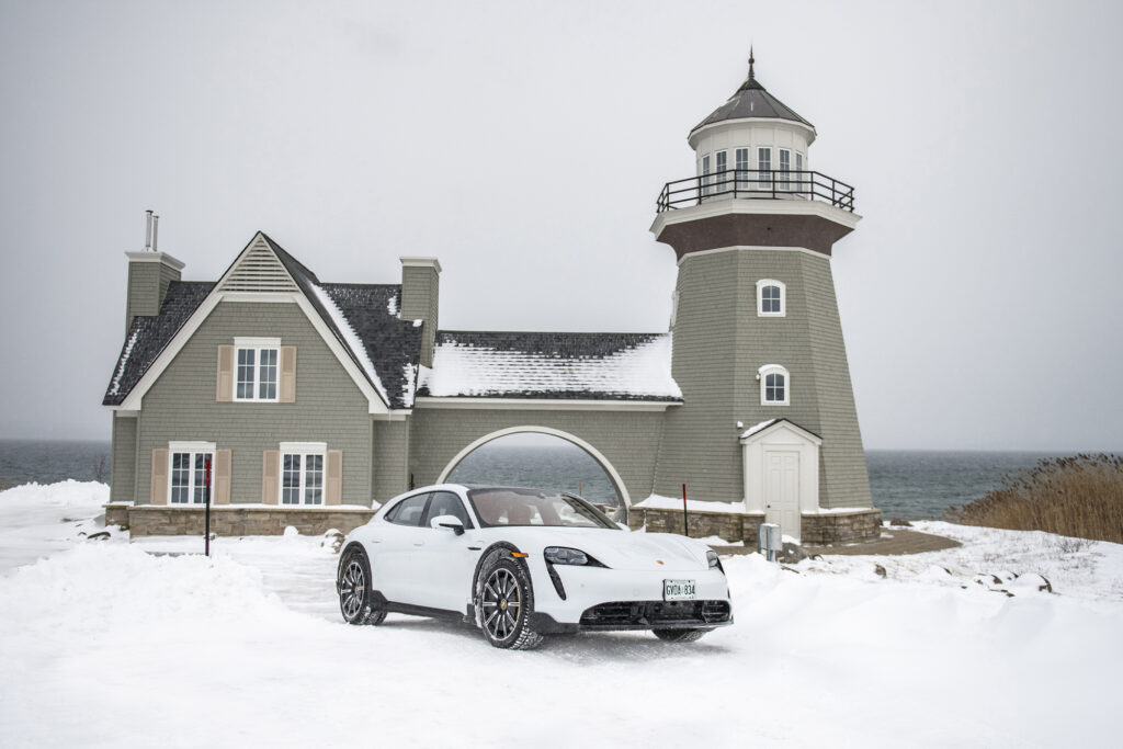 white porsche parked in the snow in front of Cobble Beach