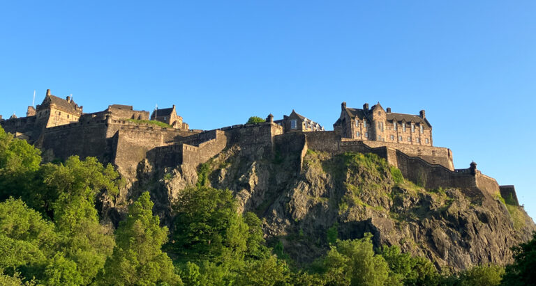 Edinburgh castle atop a cliff / hill on a clear day