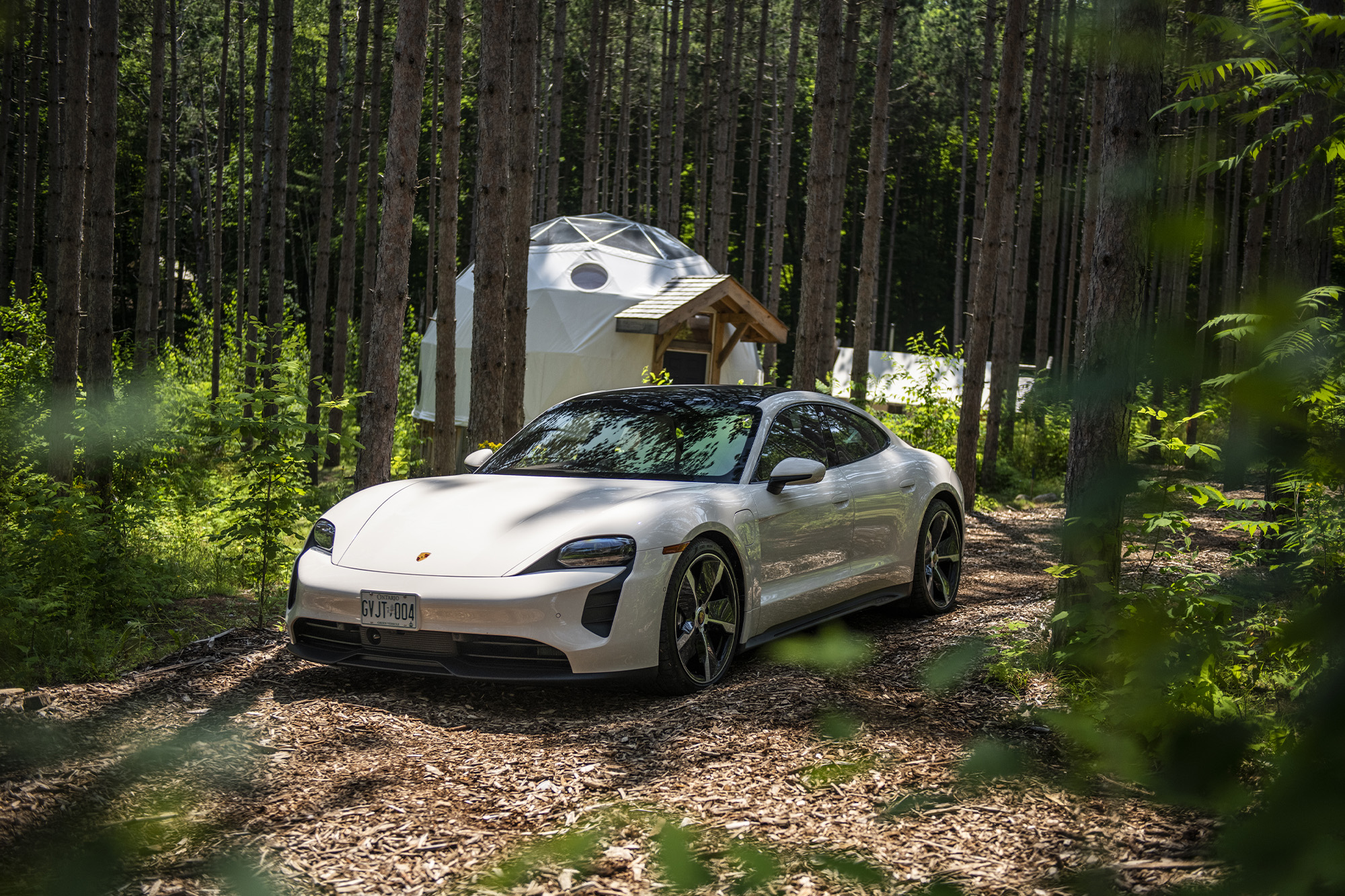 White Porsche parked deep in the woods at Glen Oro Farms
