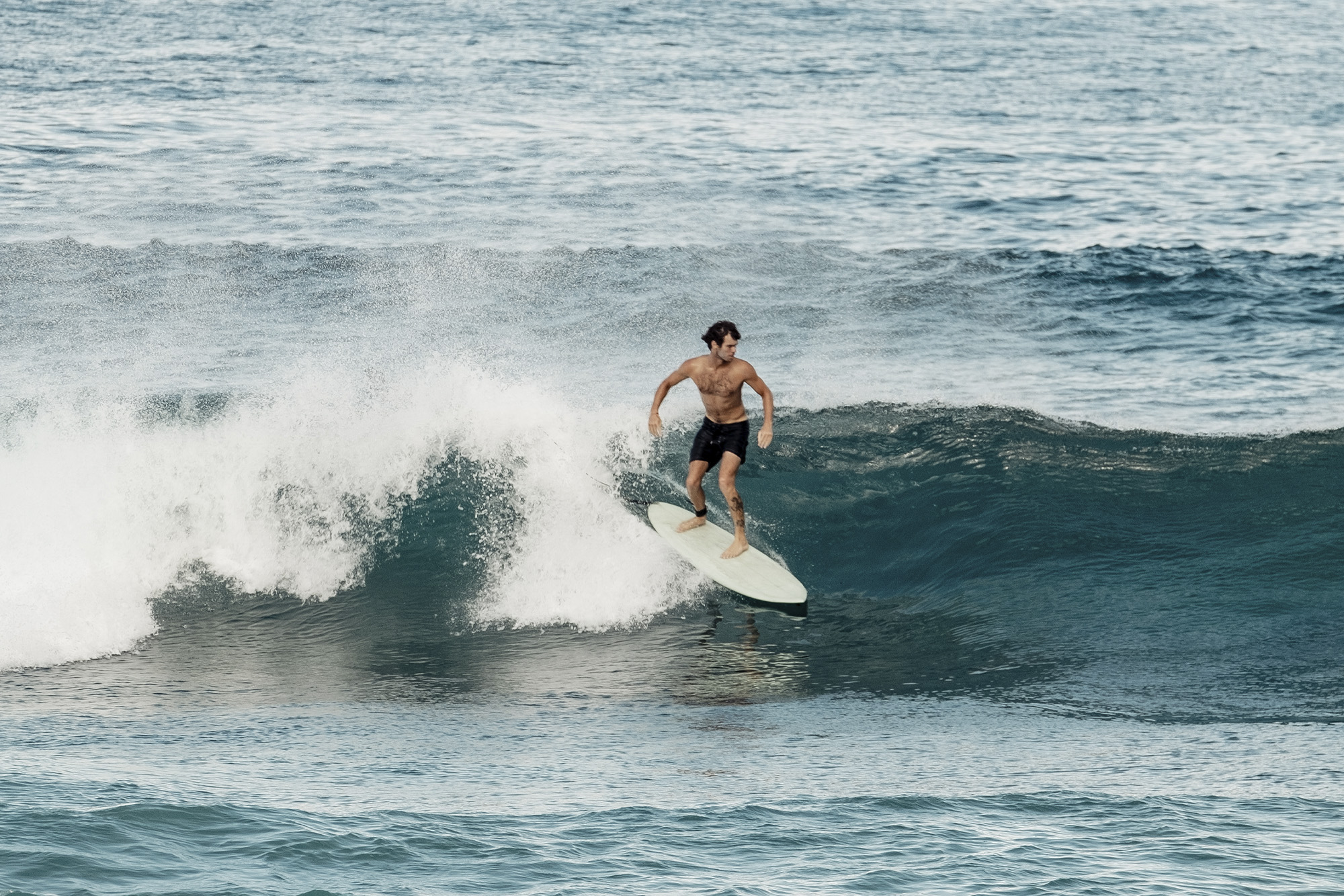 Someone surfs at Sanubari Sunda, Indonesia