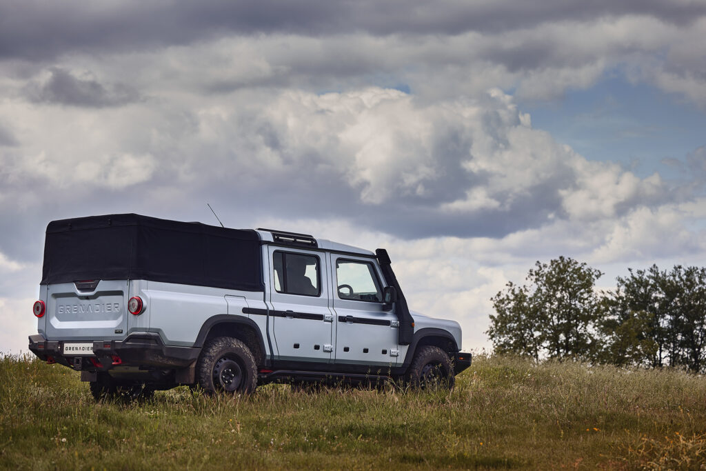 Ineos Grenadier Quartermaster drives through a grassy field