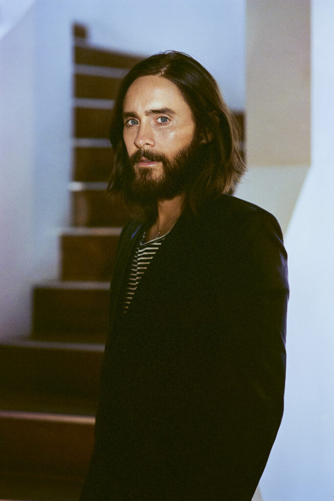 Portrait of Jared Leto in black suit by wooden stairs for SHARP September cropped close up