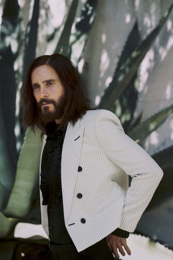 Jared Leto by wall with plant for SHARP September waist up portrait