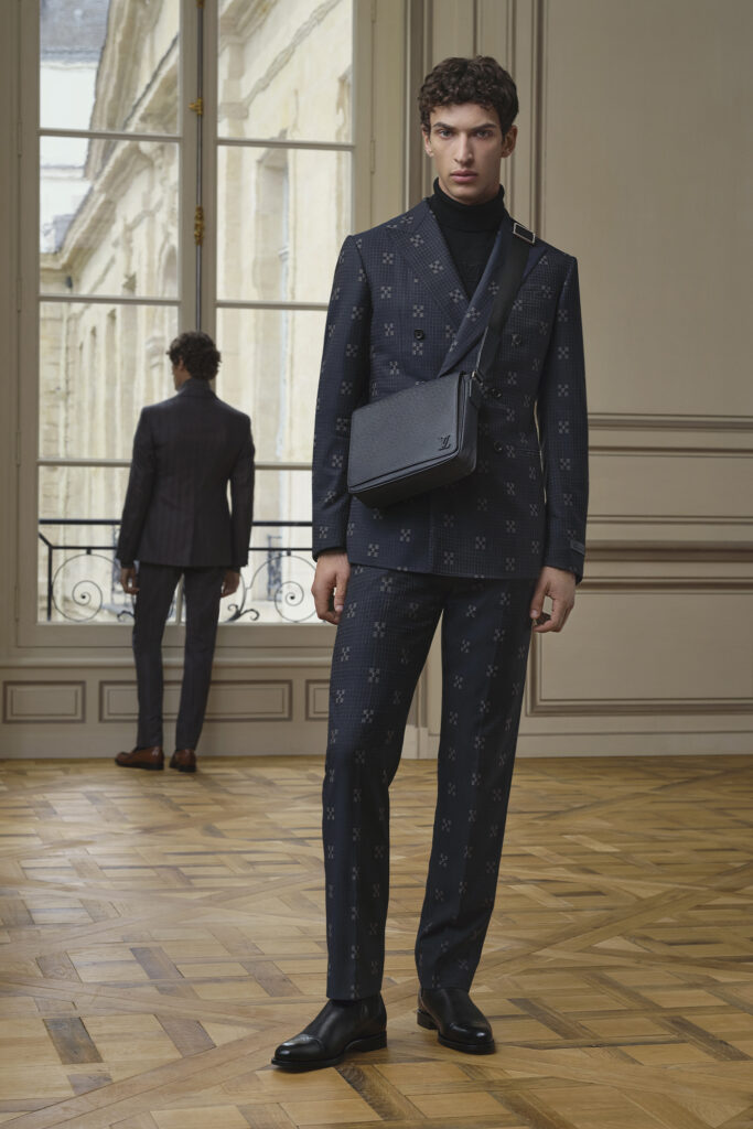 Model at Louis Vuitton spring summer 2024 show in black suit with cross body bag