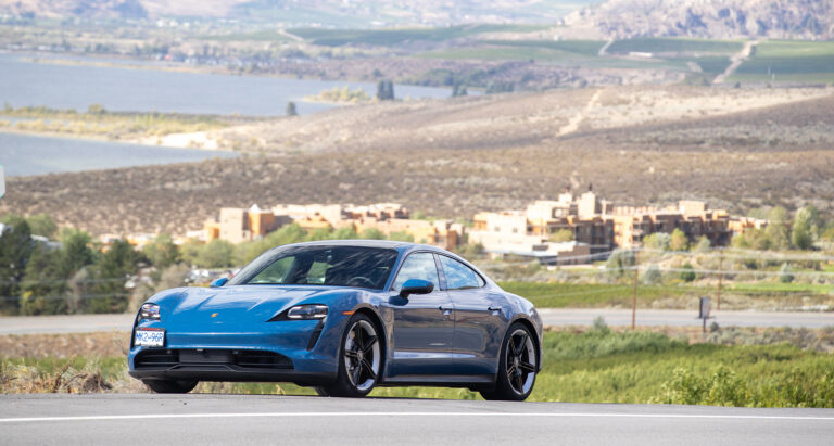 Blue Porsche Taycan driving above spirit ridge