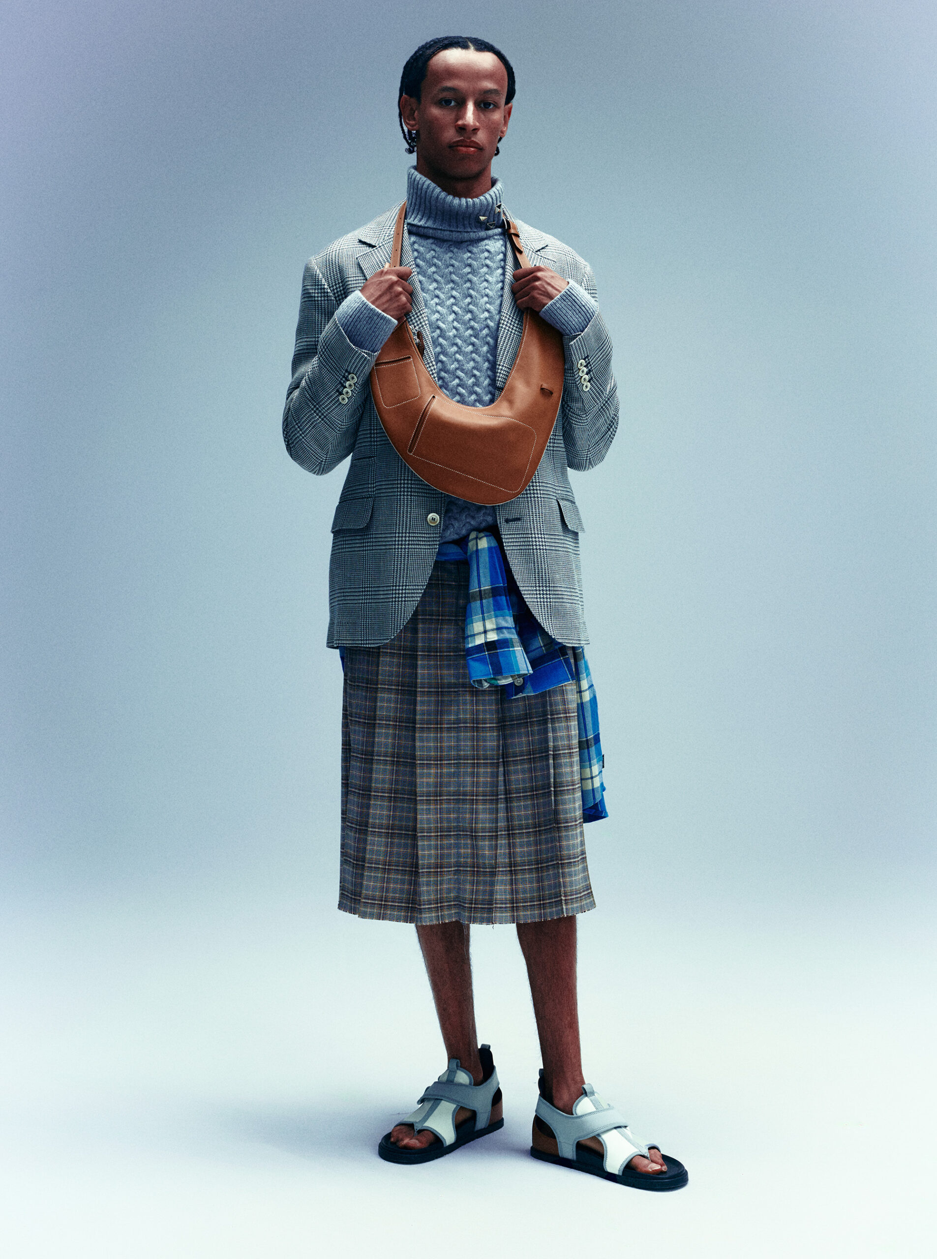 BLAZER ($4,995) AND TURTLENECK ($5,195) BY BRUNELLO CUCINELLI; BUTTON-UP SHIRT ($250) BY PAUL SMITH, AT SIMONS; SKIRT (PRICE UPON REQUEST) BY MRKNTN; BAG ($9,050) AND SHOES ($1,075) BY HERMÈS.