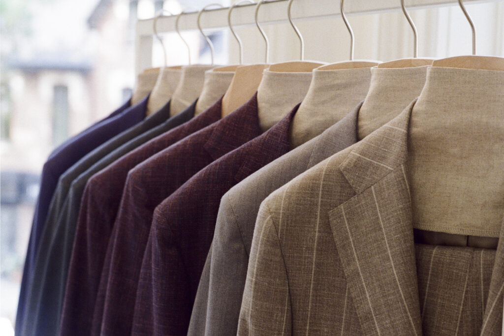suit jackets hanging on a rack at Atelier Munro