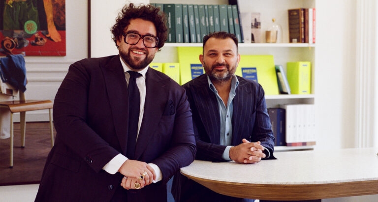 Two men pose for a photo at Atelier Munro