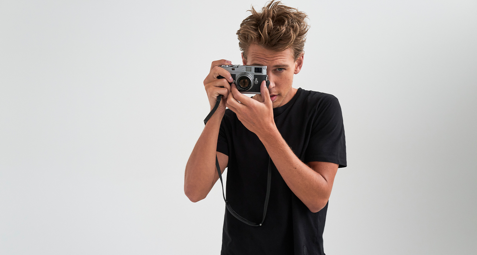 Austin Butler standing and posing with camera