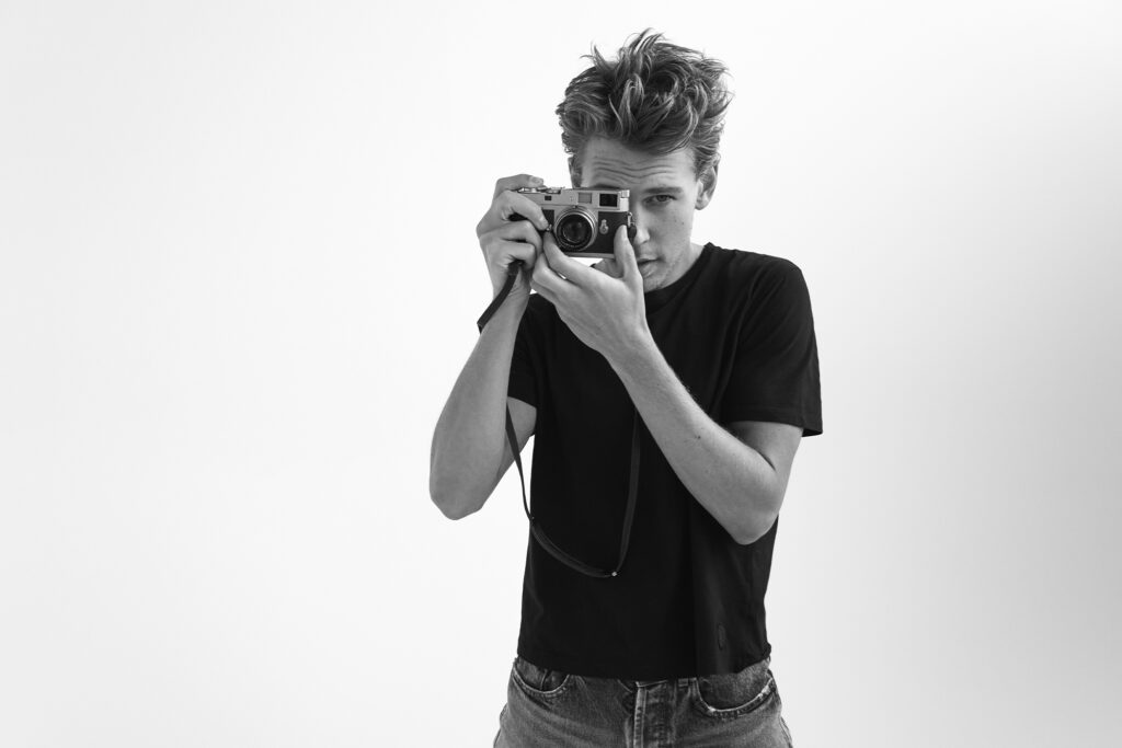 Austin Butler standing and posing with camera