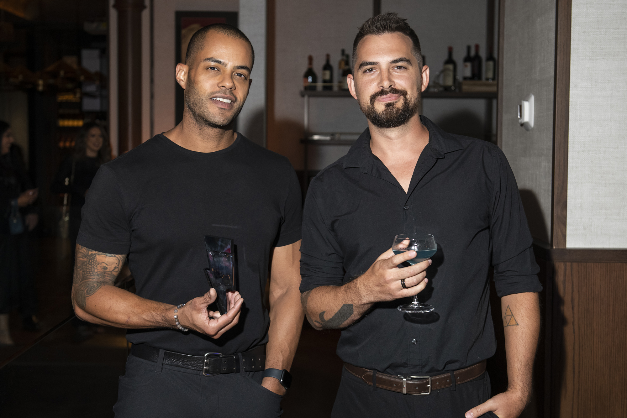 Two guests in black pose for Bad Boy Cobalt launch party at Black+Blue Toronto