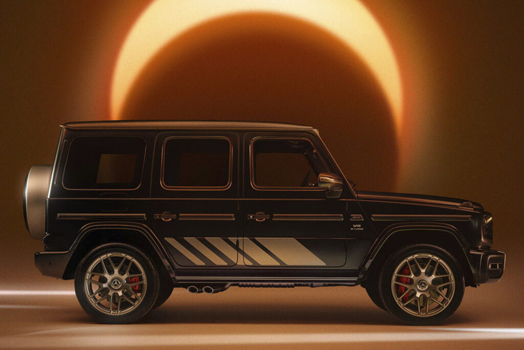 Mercedes G-Wagen shot from the side. A cresent of warm light is above the car