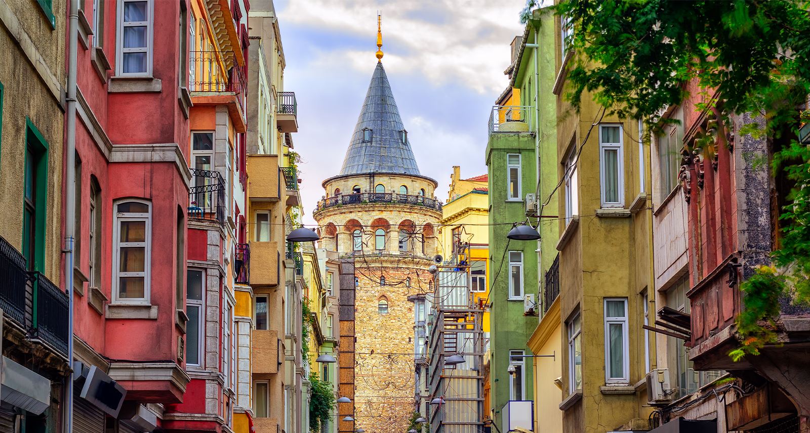 View of Istanbul from the street, a tower is framed by old houses that line the street