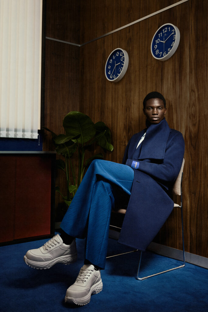 Man in blue trench coat and blue dress pants for Louis Vuitton Studio Prêt-à-Porter Homme