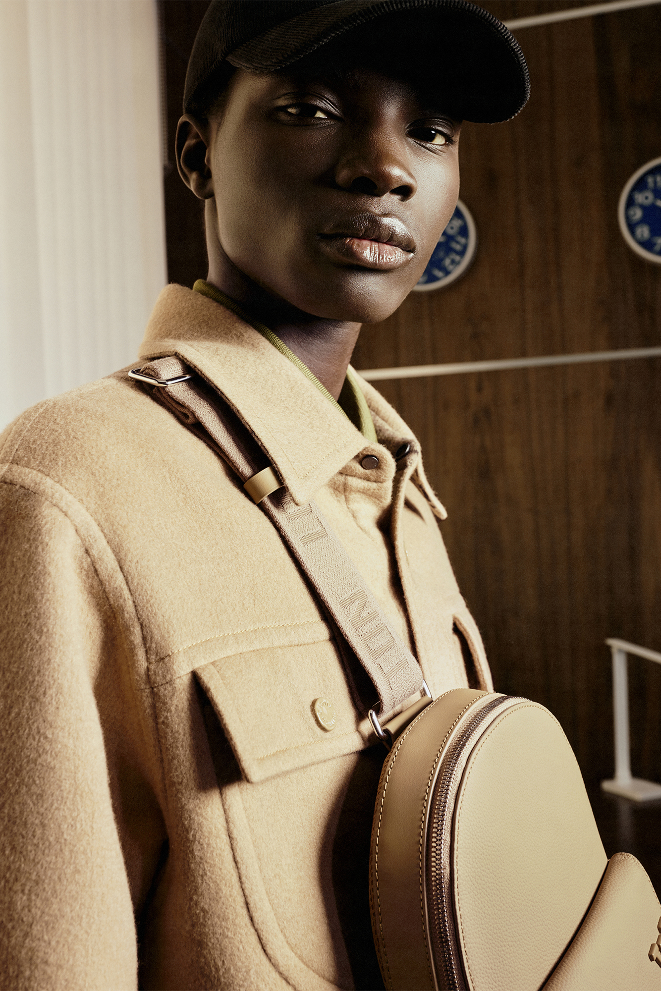 Close up of model in beige jacket with bag