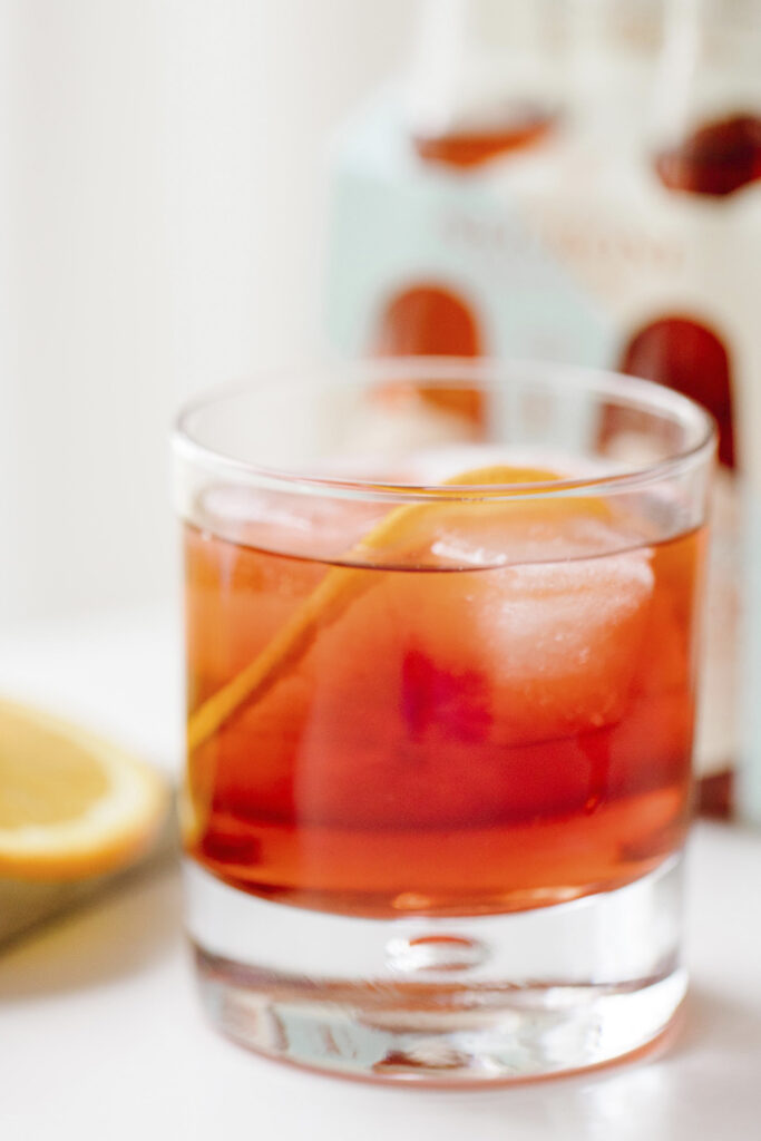 Negroni in clear glass on white counter