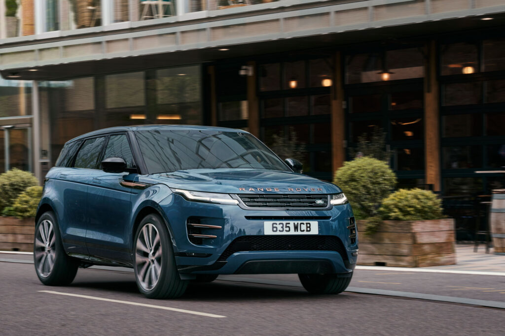 A blue Range Rover Evoque shot from the front left while driving.