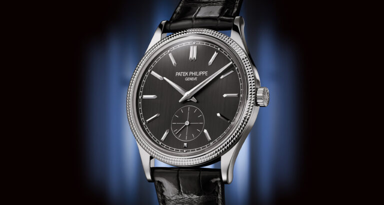 Patek Philippe Calatrava 6119G-001 dial on black background with blue light behind it