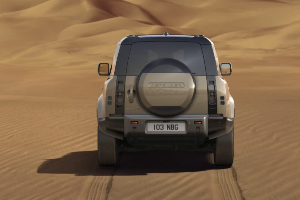SHARP built Land Rover Defender shot from the back, parked in desert
