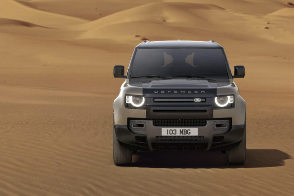 SHARP built Land Rover Defender parked in a desert facing the camera